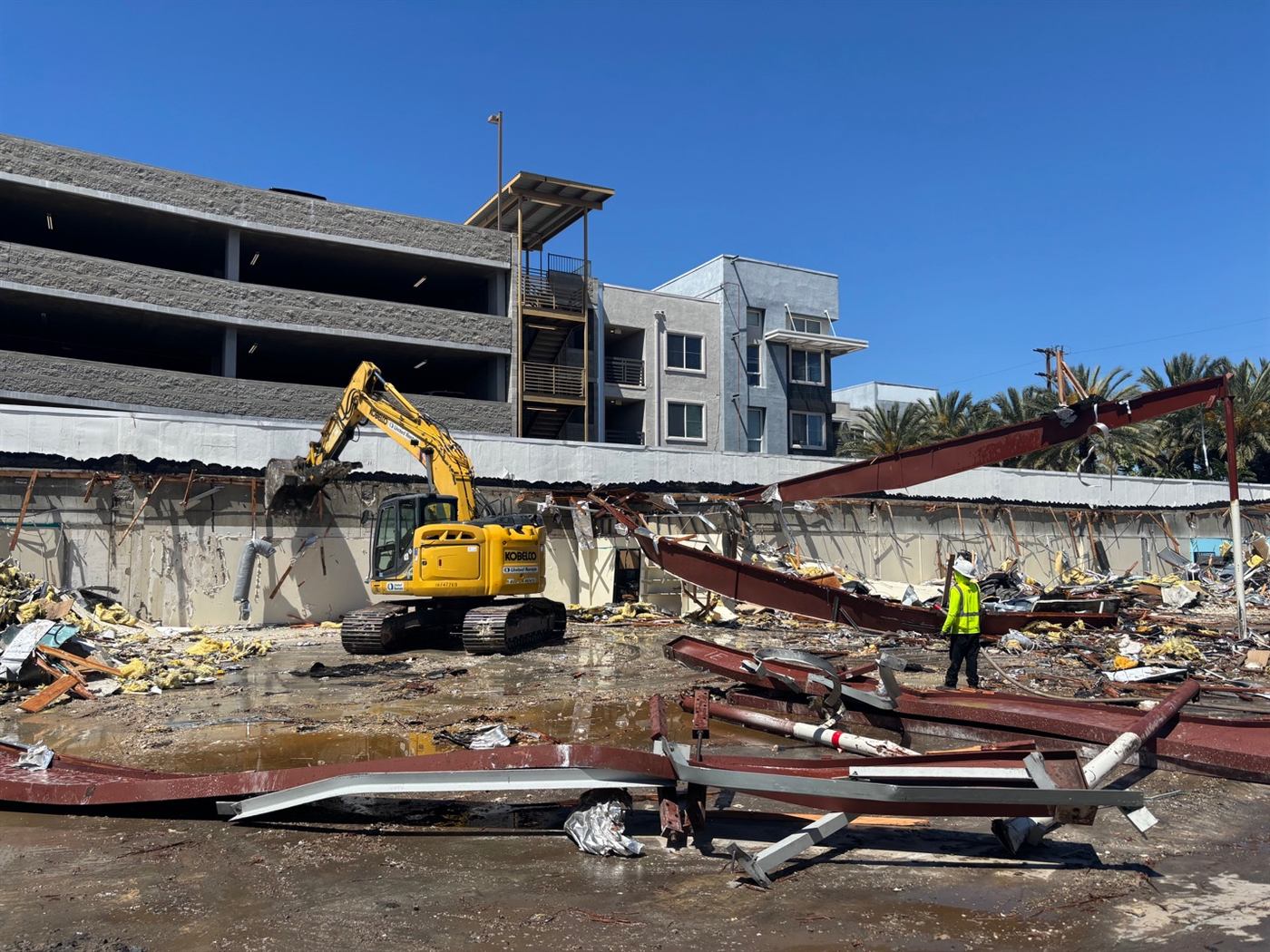 Exposed steel and wood truss framework of a building mid-demolition