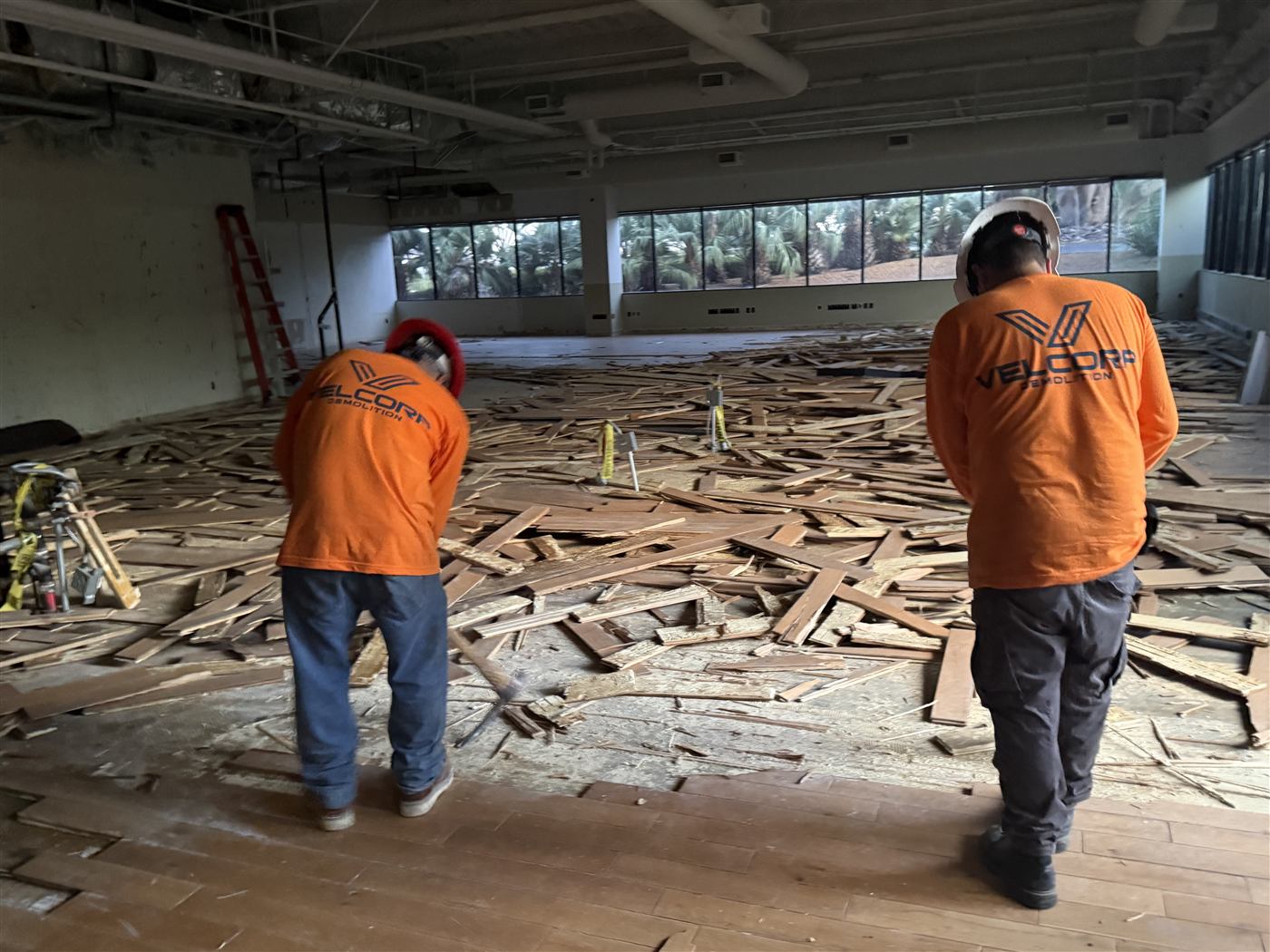 Velcorp Demolition crew stripping flooring inside a commercial building