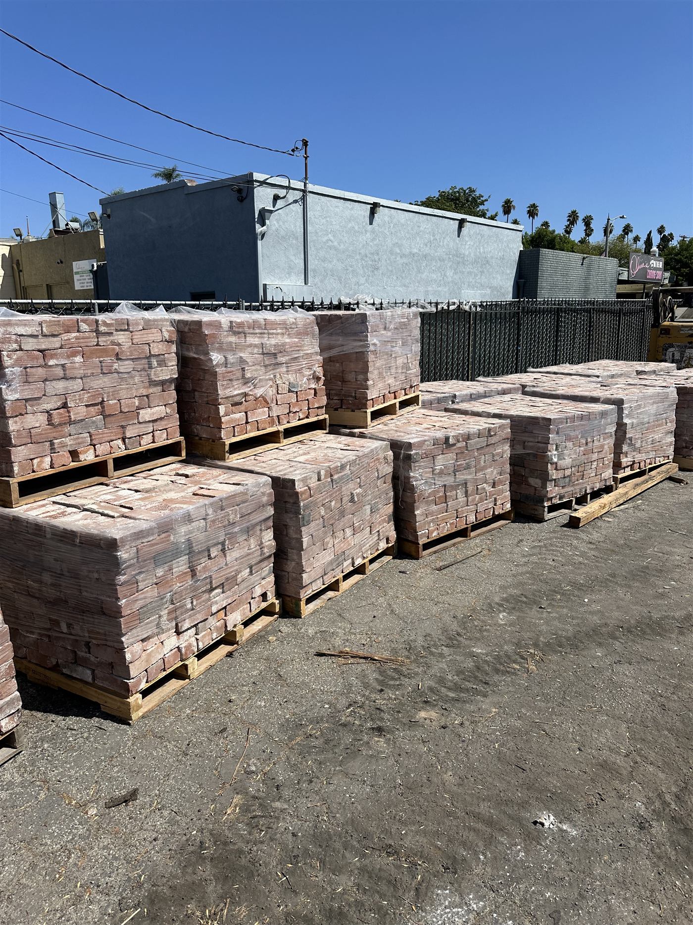 Pallets of reclaimed brick staged for recycling
