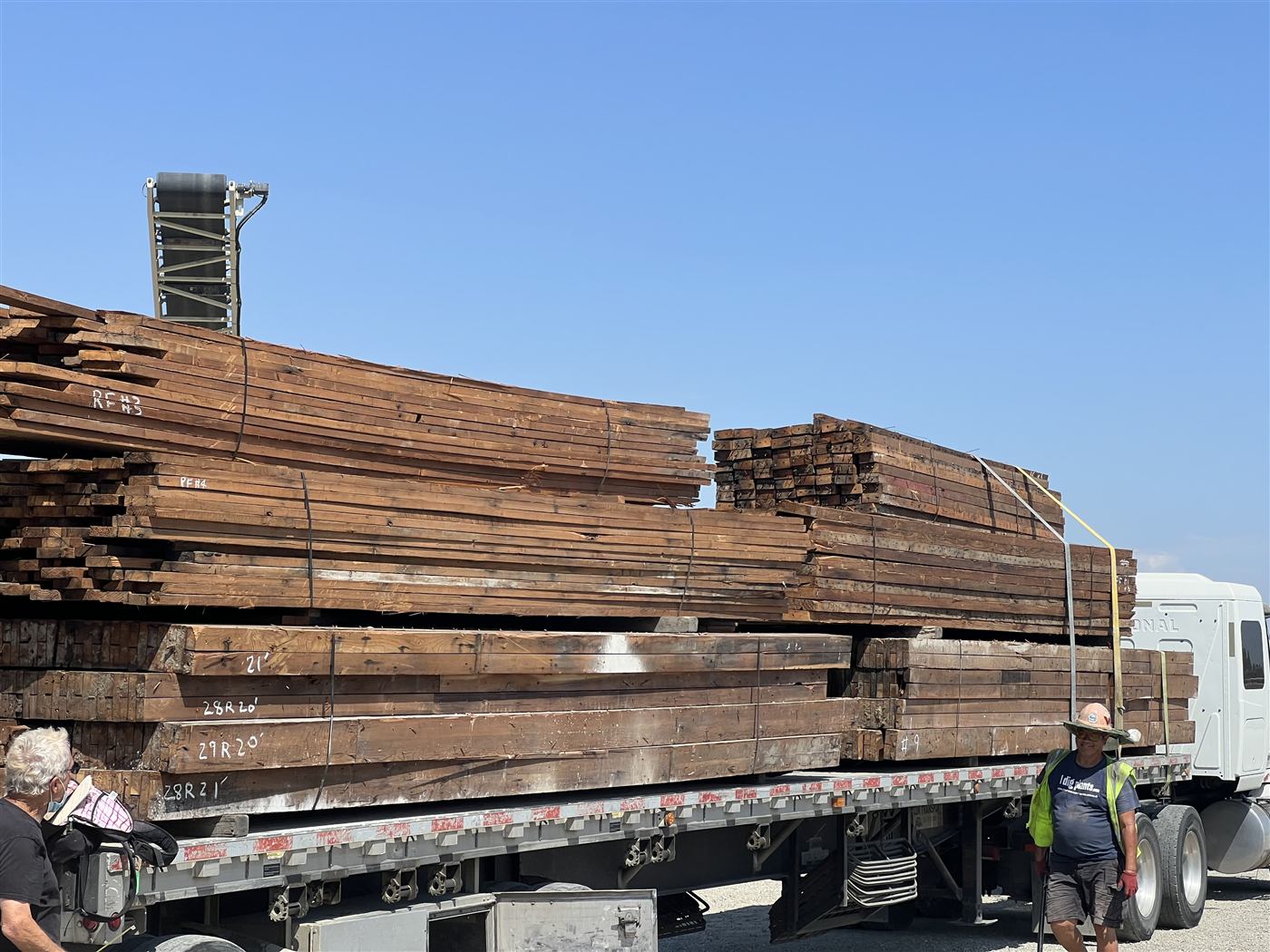 Flatbed truck loaded with reclaimed heavy timber beams